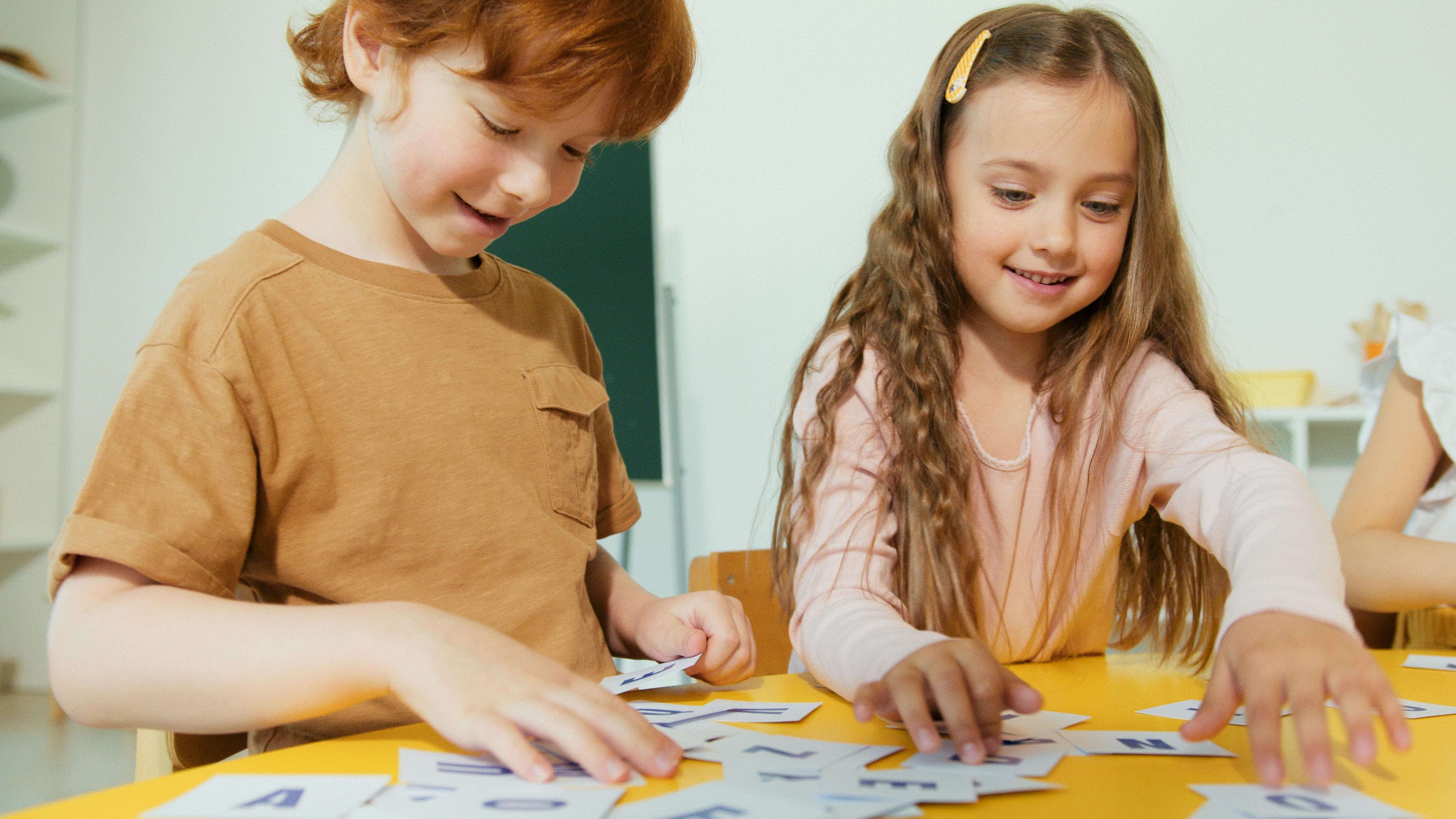 Students studying with colorful flashcards spread across a desk